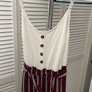 Business casual jump suit. White button top, maroon striped paper bag pants.